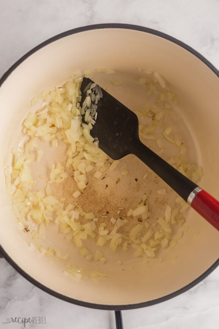 onion cooking in large dutch oven with spatula