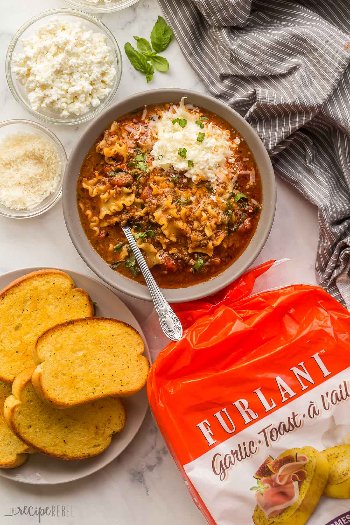 overhead image of lasagna soup in bowl with package of furlani garlic bread