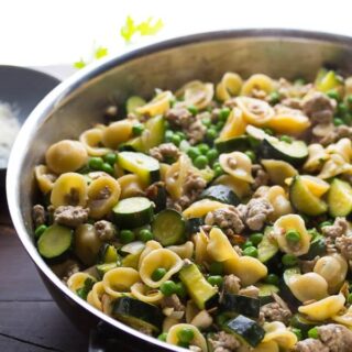 A skillet of one pan pasta with ground turkey an zucchini.