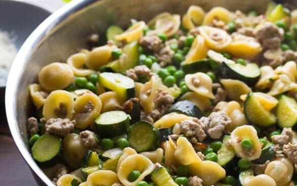 A skillet of one pan pasta with ground turkey an zucchini.