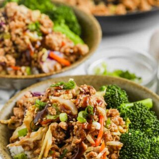 Sesame ground turkey served in bowls over rice with broccoli.