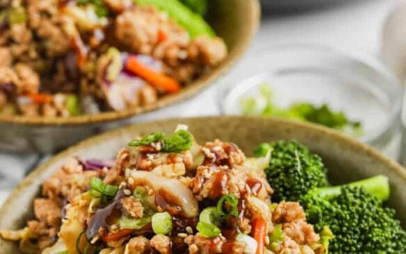 Sesame ground turkey served in bowls over rice with broccoli.