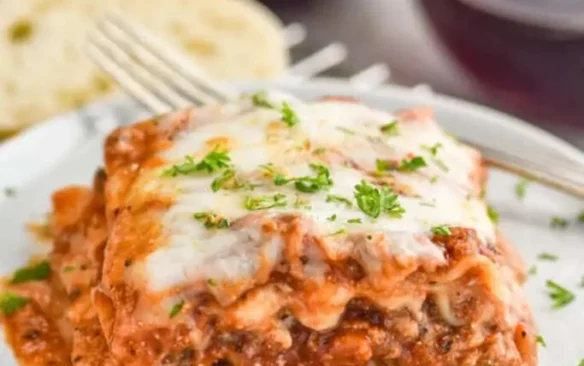 A slice of turkey lasagna on a plate.