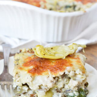 A slice of creamy turkey and wild rice casserole on a plate.