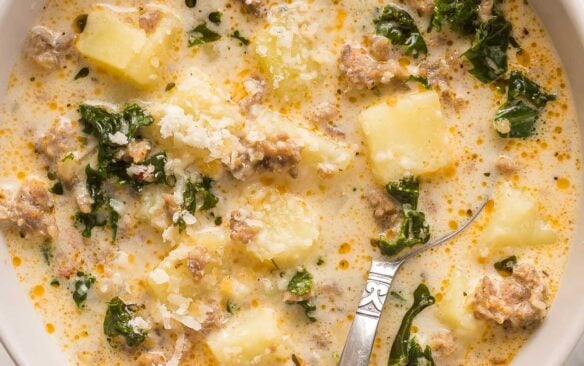 close up image of zuppa toscana in bowl with spoon