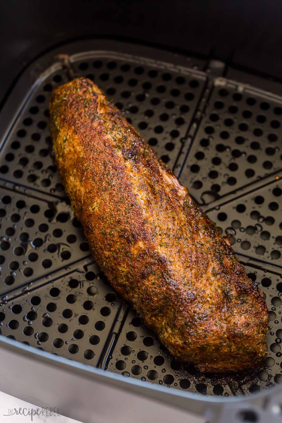 finished pork tenderloin in basket of air fryer