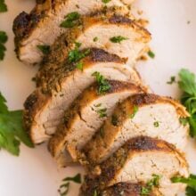 close up image of sliced air fryer pork tenderloin with fresh parsley