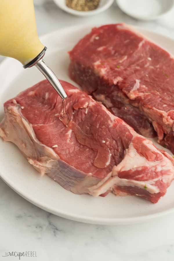 striploin steaks drizzled with oil