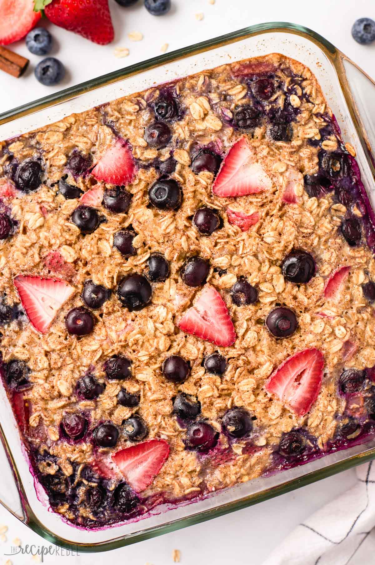 overhead close up image of baked oatmeal with blueberries and strawberries