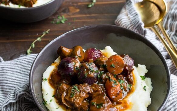 Beef bourguignon served over mashed potaotes.