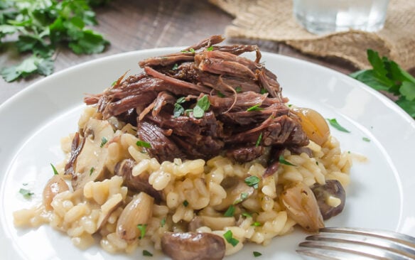 Slow cooker short ribs served over mushroom risotto.