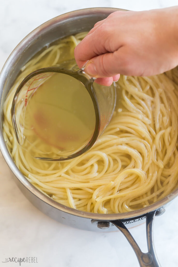 glass measuring cup reserving water from cooked pasta