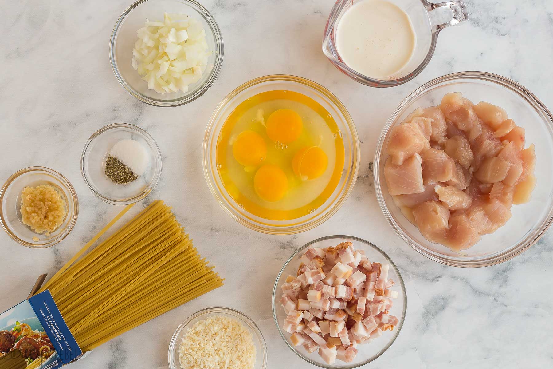 ingredients for chicken carbonara on white background