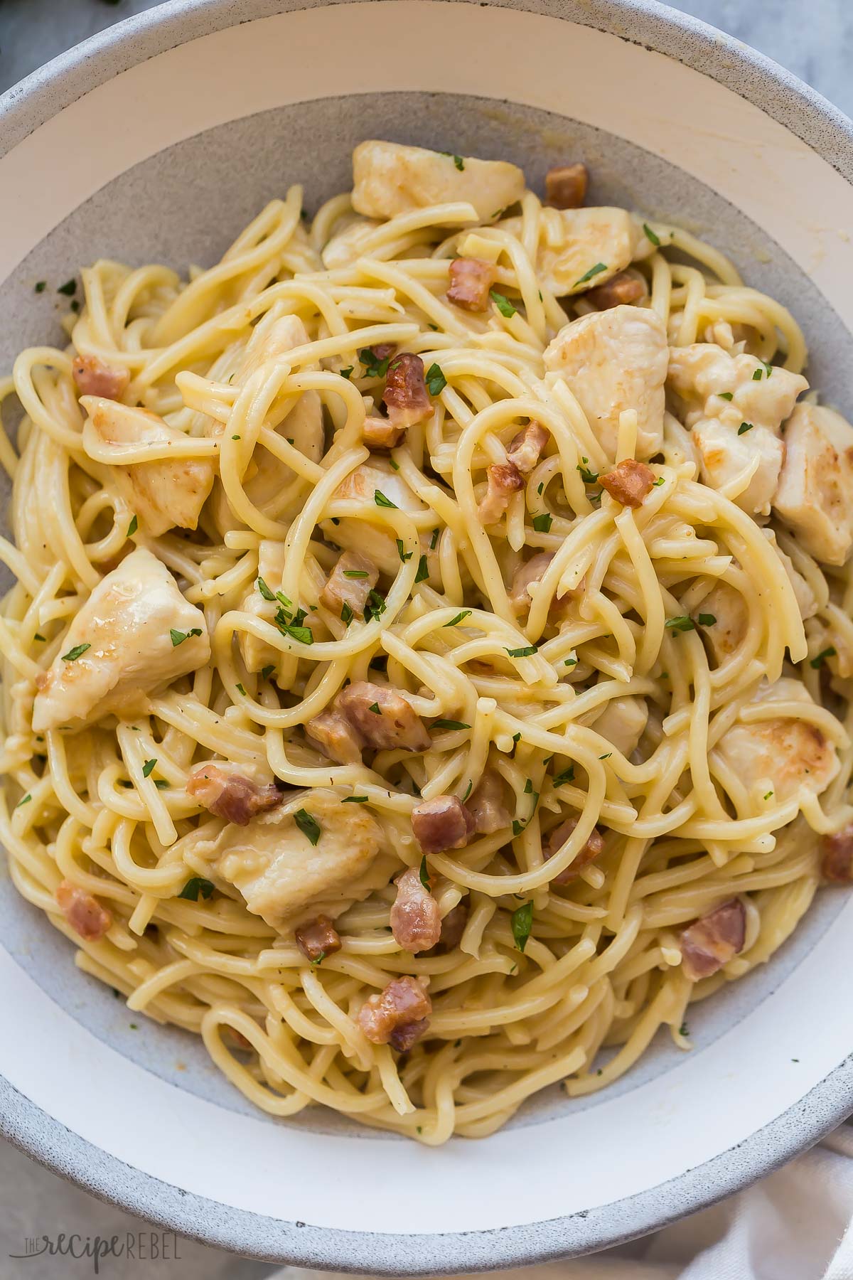overhead image of bowl of chicken carbonara pasta with chicken and bacon