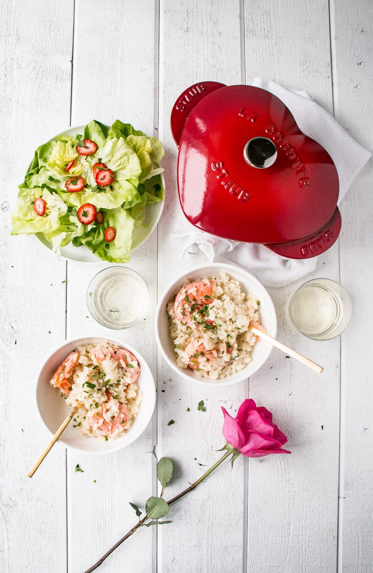 Date night risotto served in bowls next to a heart-shaped Dutch oven.