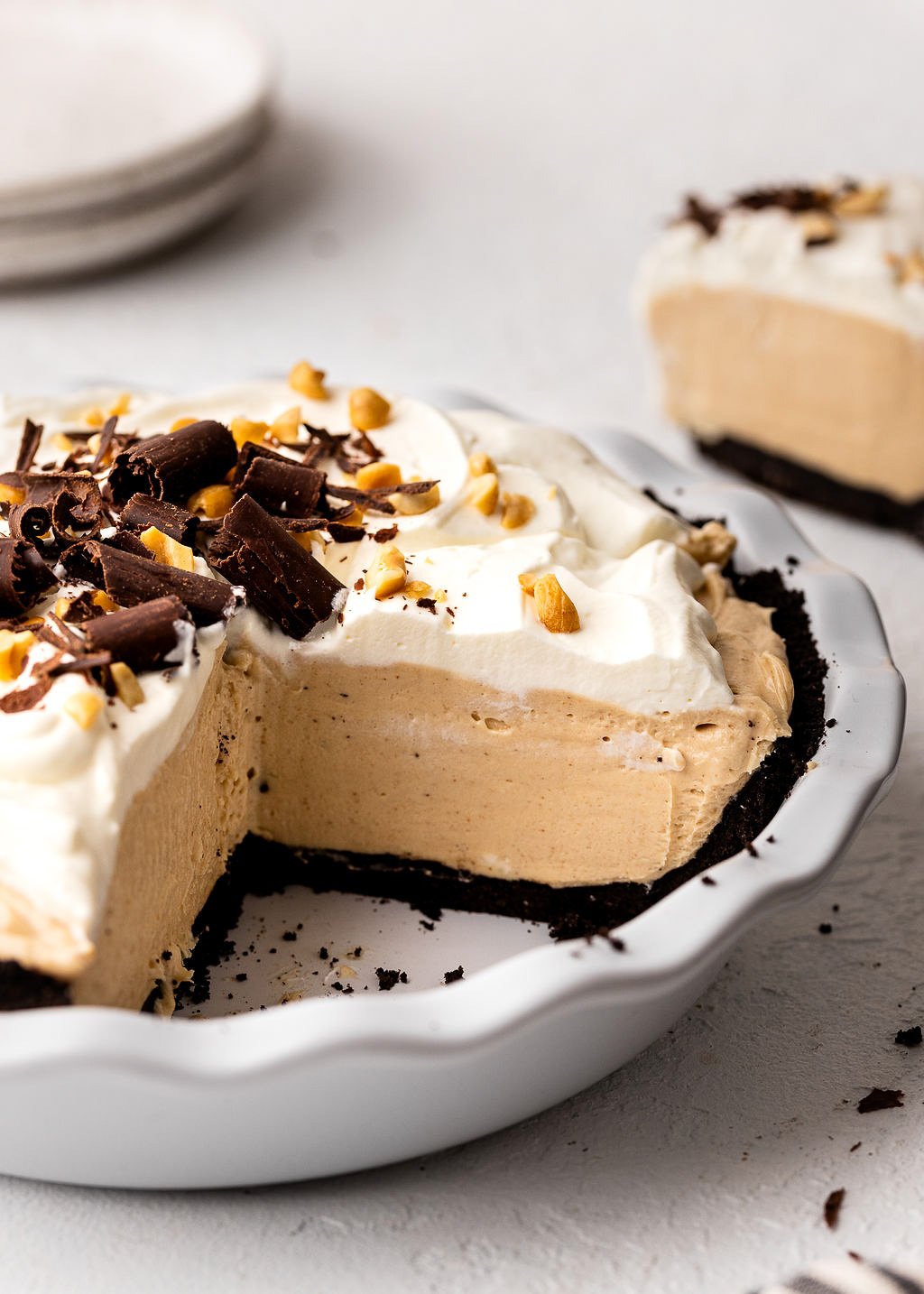 peanut butter pie in pie plate with piece cut out.