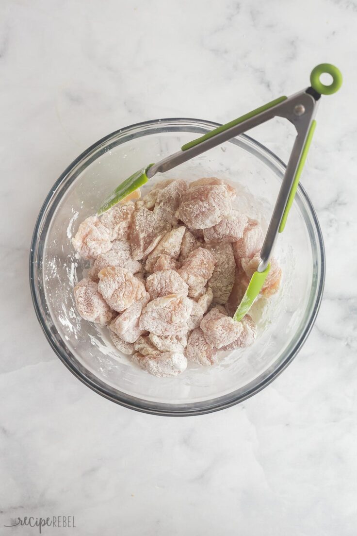 chicken pieces in glass bowl coated in corn starch