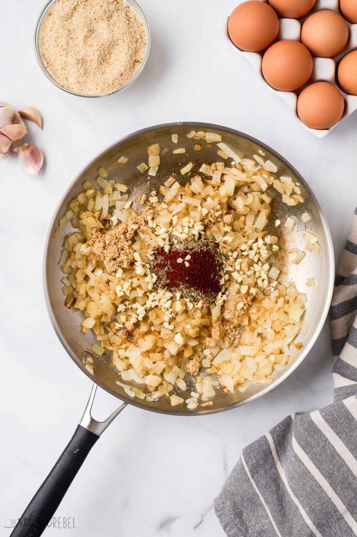 seasonings added to cooked onions in skillet