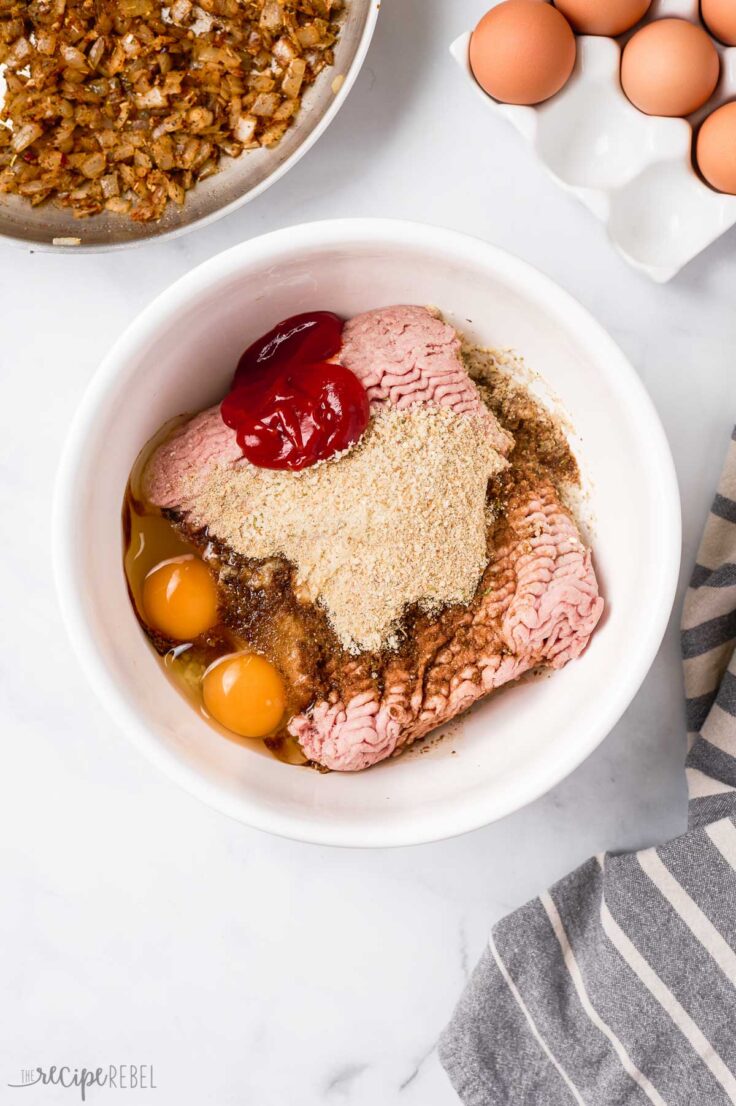 ground turkey with meatloaf ingredients in white bowl