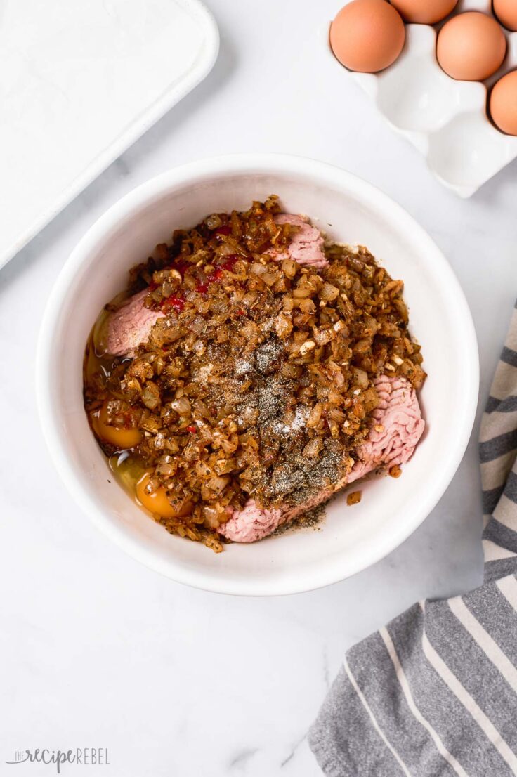 cooked seasoned onions added to meatloaf mixture in bowl