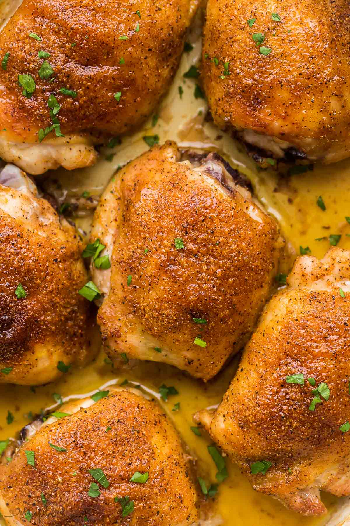 very close up image of a baked chicken thigh