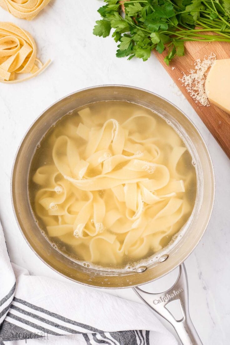 cooked pappardelle in stainless steel pot ready to drain