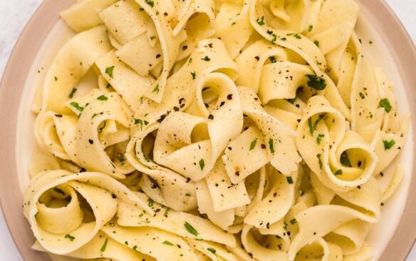 overhead image of plate of buttered noodles with parsley