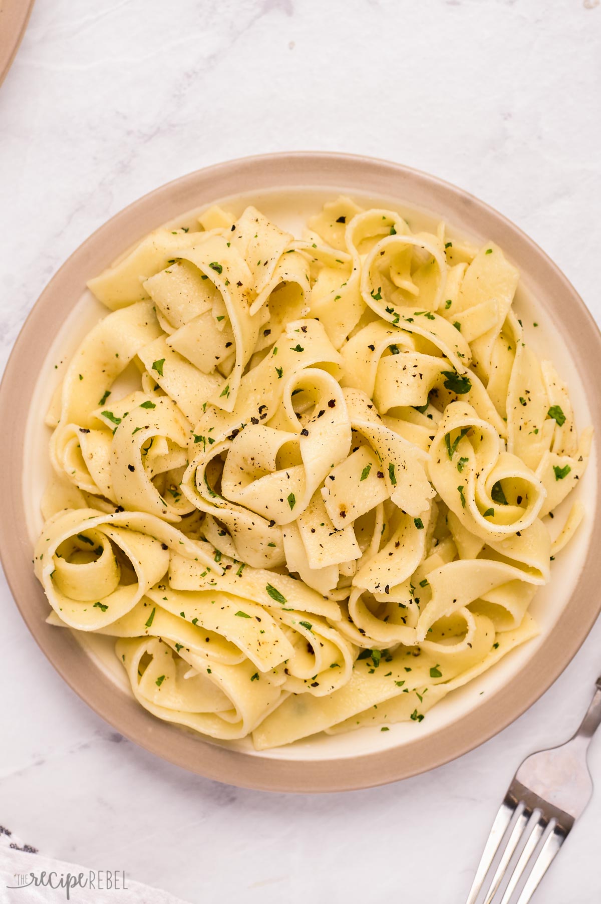 overhead image of plate of buttered noodles with parsley