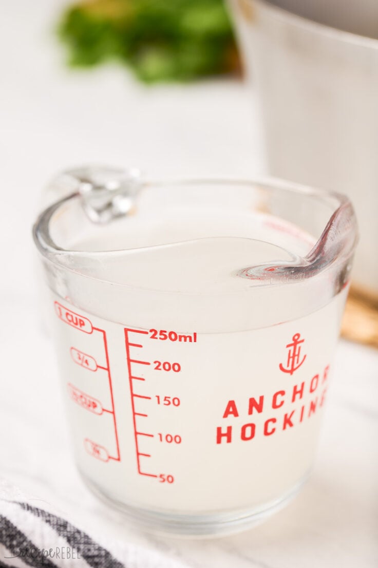 reserved pasta water in a glass measuring cup