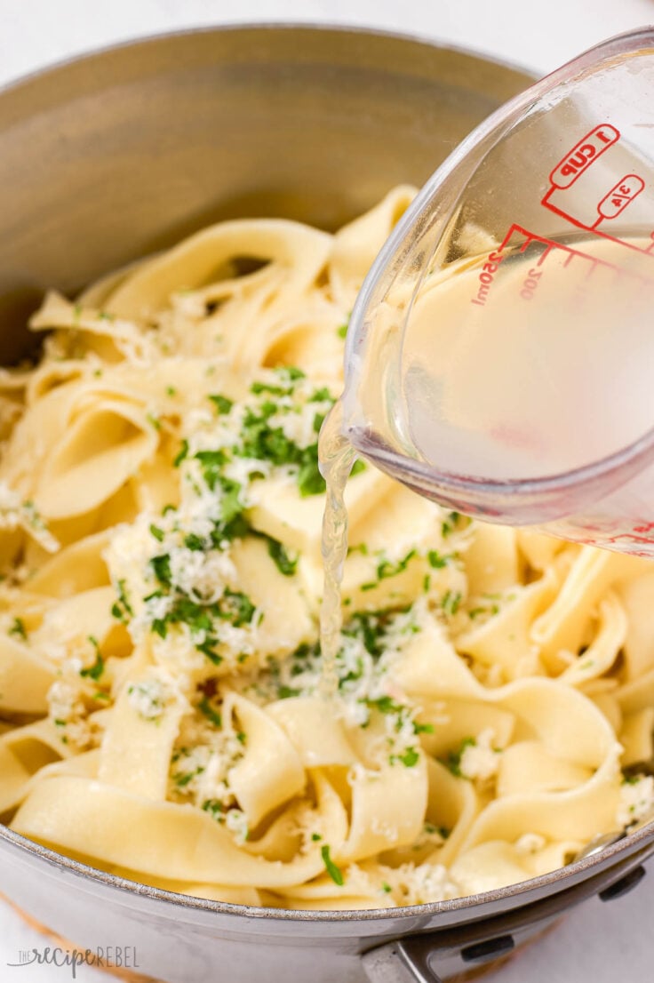 reserved pasta water being added to noodles in pot