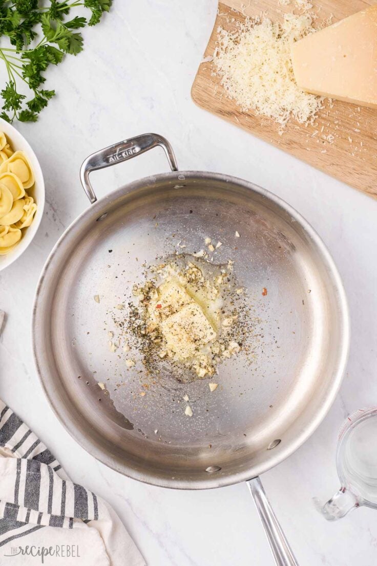 garlic and spices sauteeing in stainless steel pan