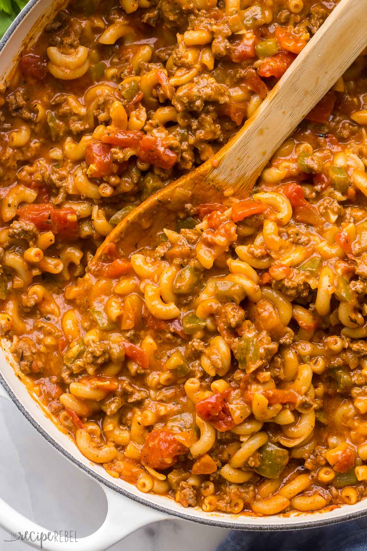 close up image of goulash in pan with wooden spoon
