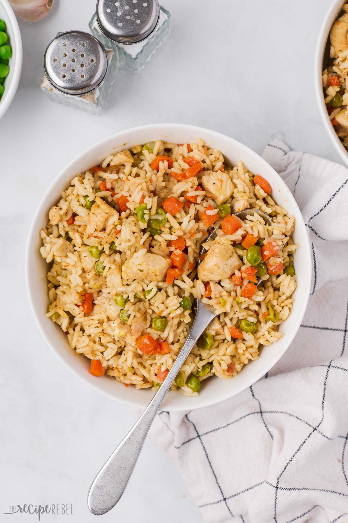 overhead image of instant pot chicken and rice in white bowl with a spoon