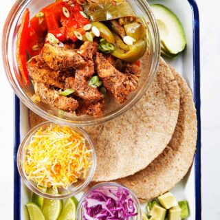 A tray of chicken fajitas ingredients.