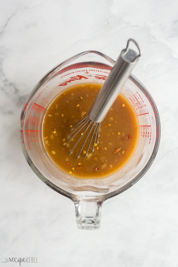 pineapple chicken stirred together in glass measuring cup