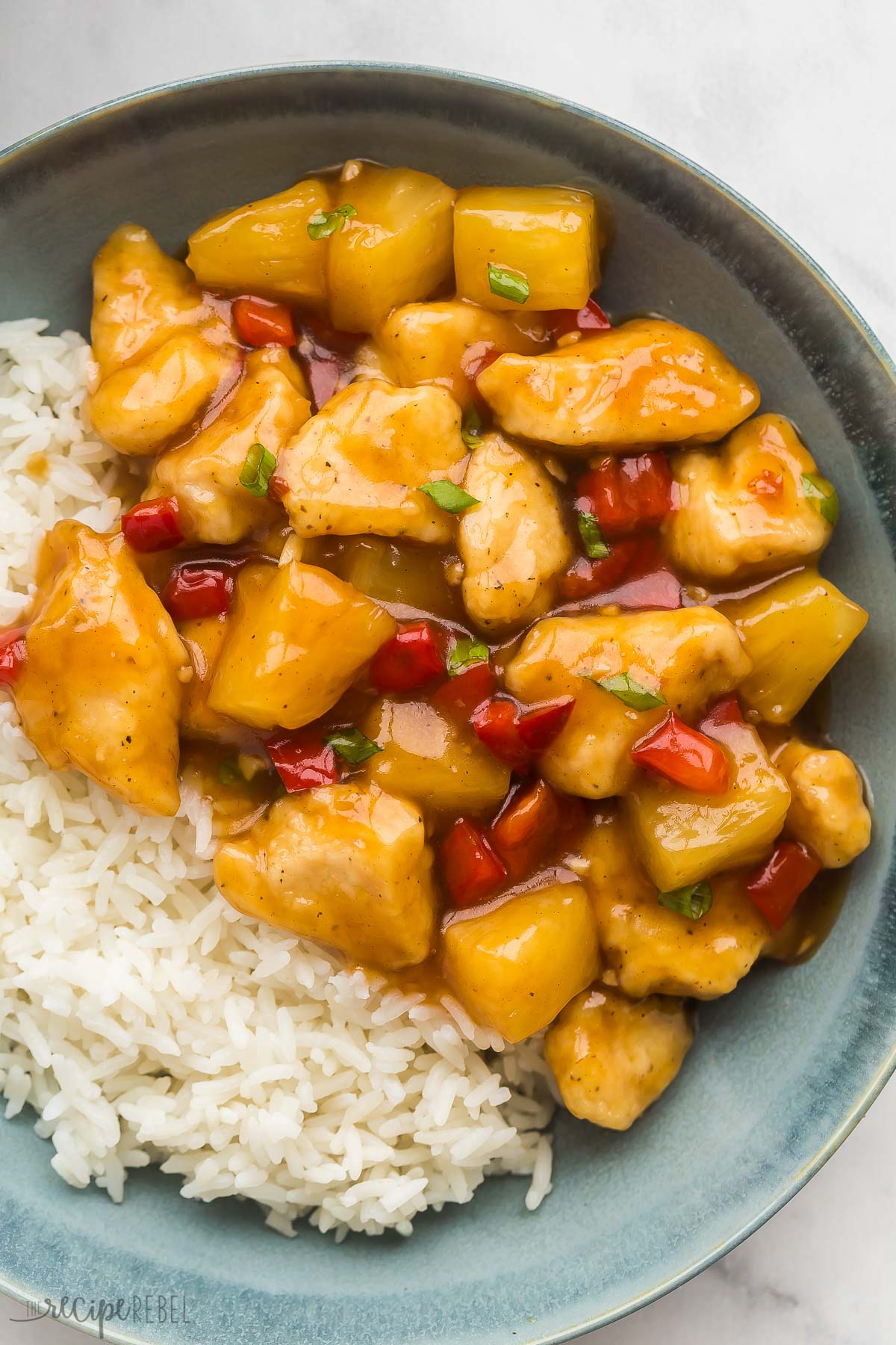 overhead close up image of pineapple chicken with peppers and green onions