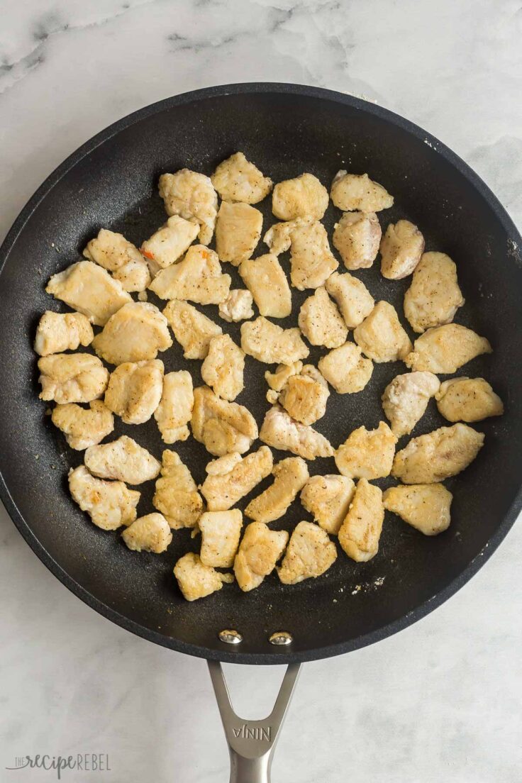 chicken pieces browned in black skillet