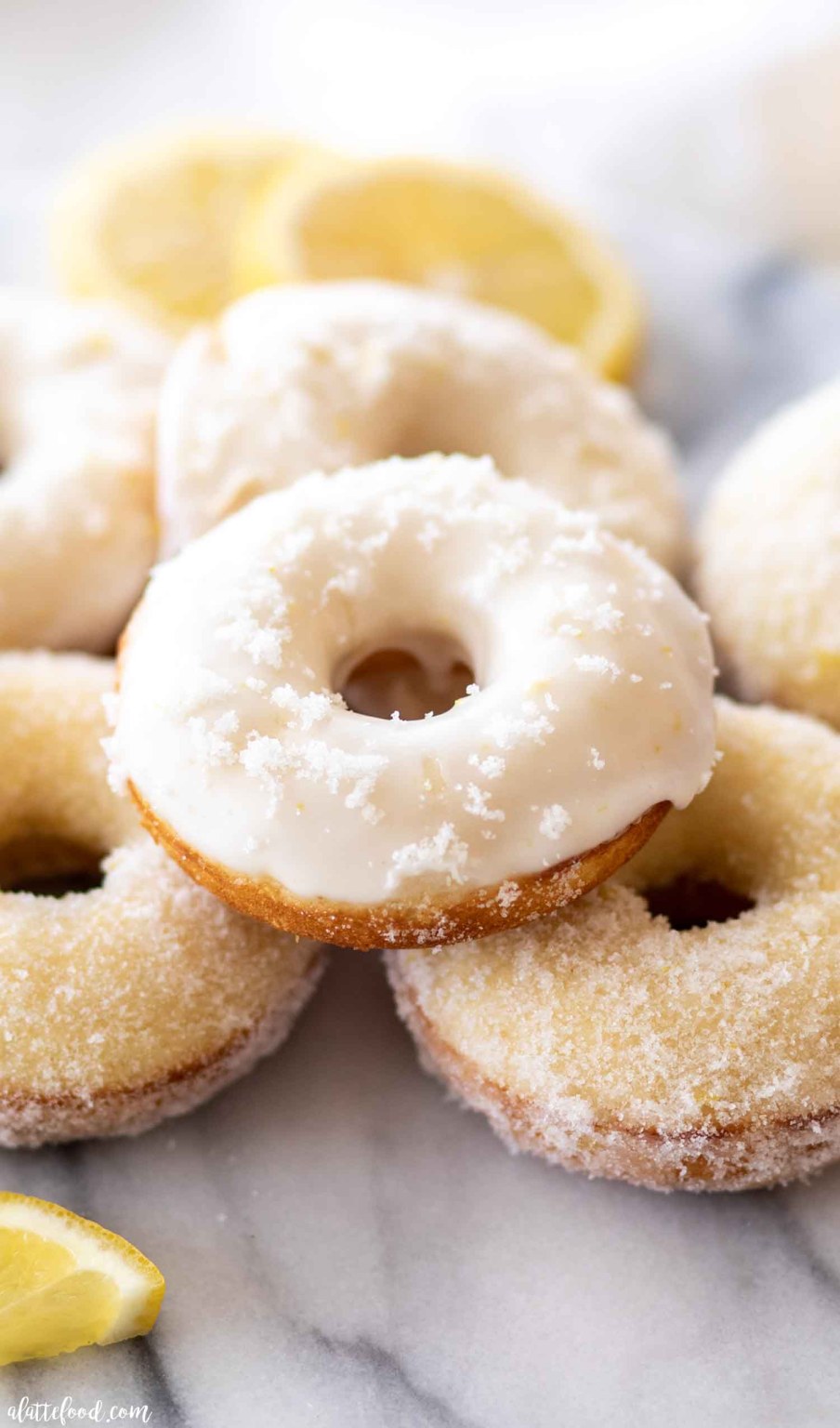 A pile of glazed baked lemon donuts.