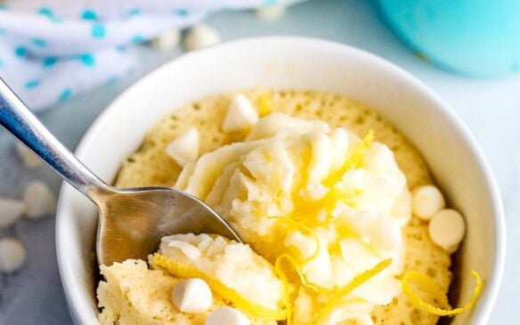 A lemon mug cake with a spoon.