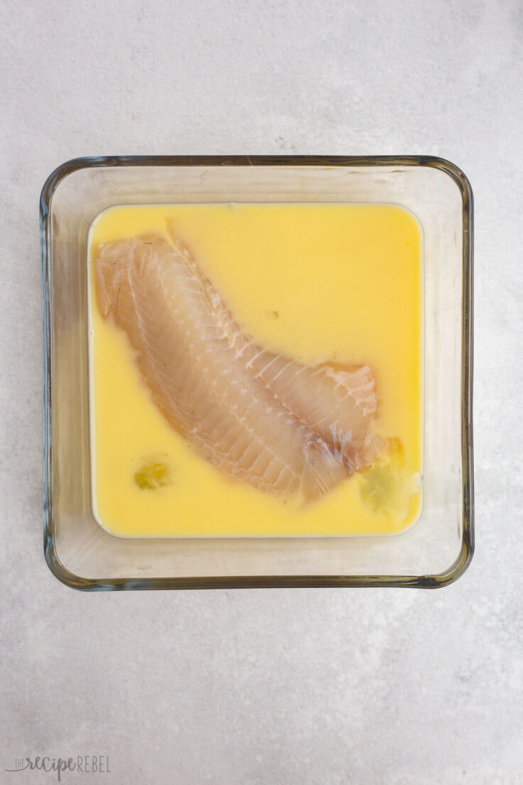 tilapia being coated in egg and milk