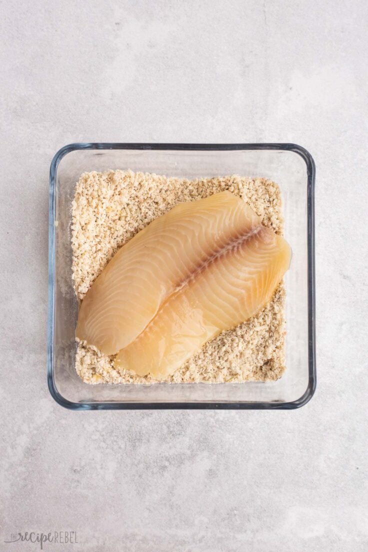 tilapia being coated in bread crumb mixture