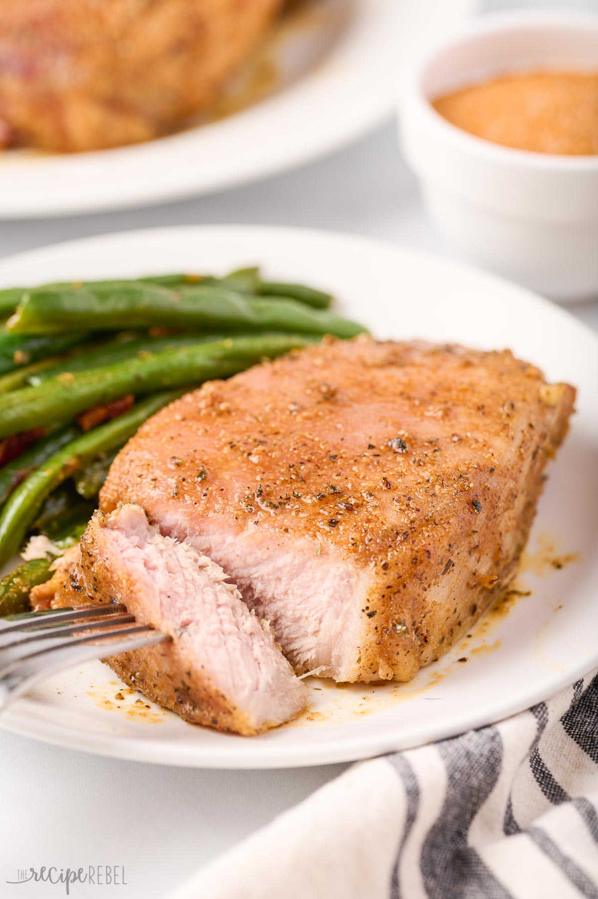 close up image of baked pork chop cut open