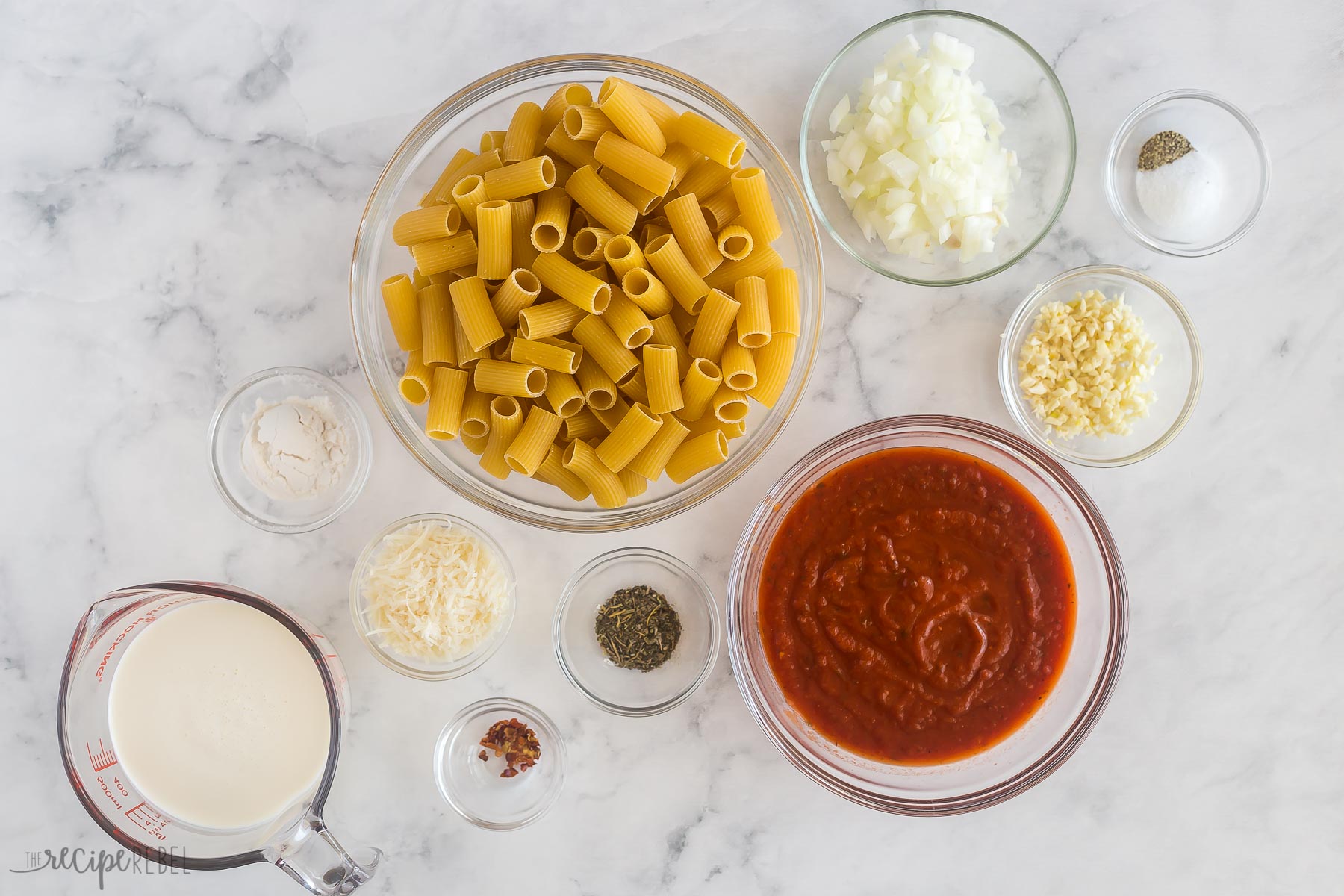This Creamy Tomato Rigatoni Pasta is the perfect easy weeknight dinner! It's a 25-minute recipe made with tender rigatoni pasta that are tossed in a rich, creamy, and flavorful tomato sauce and finished off with a sprinkle of parmesan. #rigatoni #dinner | easy dinner ideas | 30 minute meals | easy recipes | pasta | rigatoni pasta | comfort food ingredients needed for creamy tomato rigatoni pasta