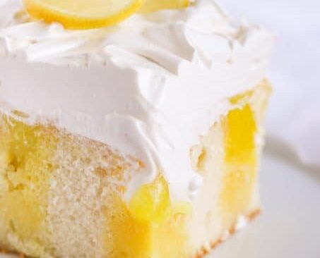 A slice of lemon marshmallow poke cake.