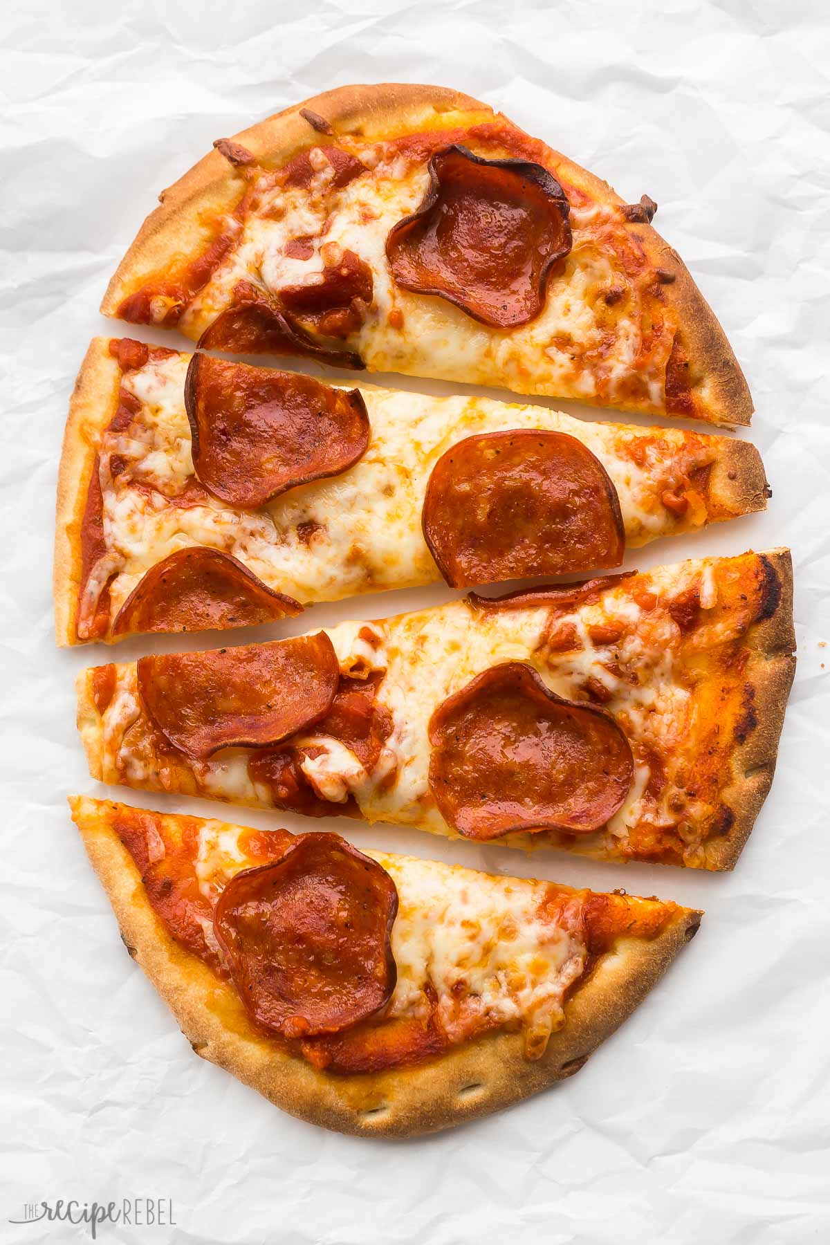 overhead image of pepperoni flatbread pizza cut into four pieces