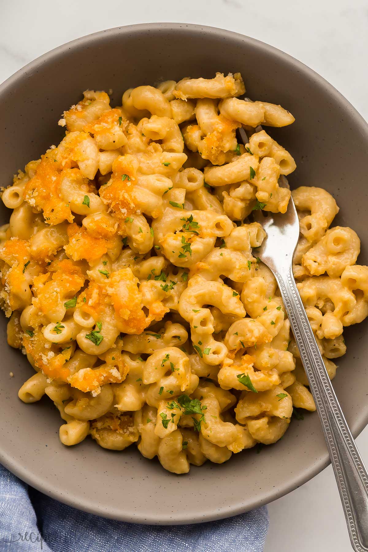 baked mac and cheese in a bowl with a fork stuck in