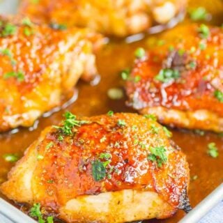 Close up of honey balsamic chicken thighs in a baking dish.