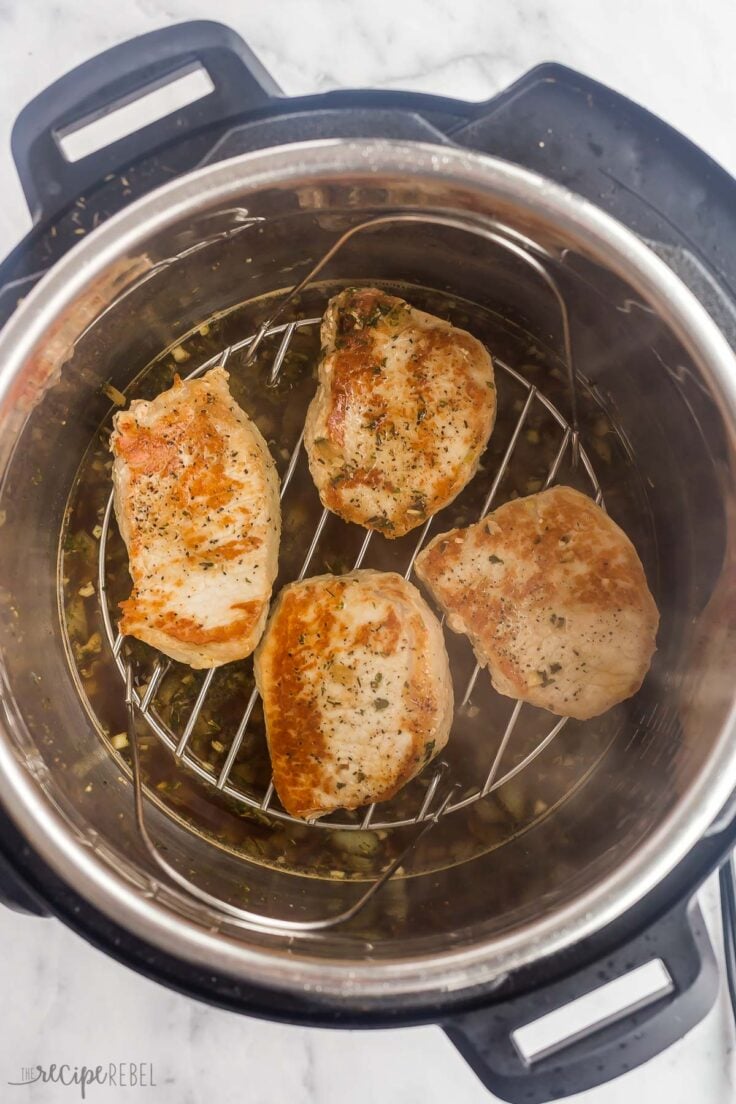 browned pork chops on trivet in instant pot