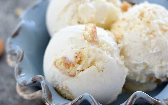 A bowl full of lemon cheesecake ice cream scoops.