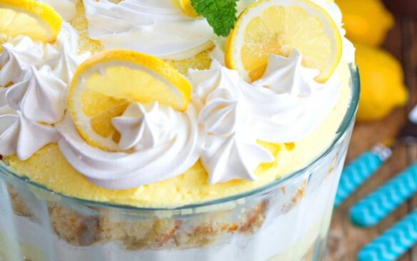 A lemon trifle topped with swirls of lemon and cream.